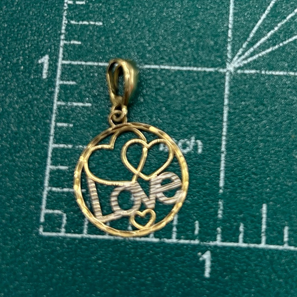 "Love" Circle Pendant in 10K
Two Tone Gold Double hearts  0.5 Grams hangs 1"